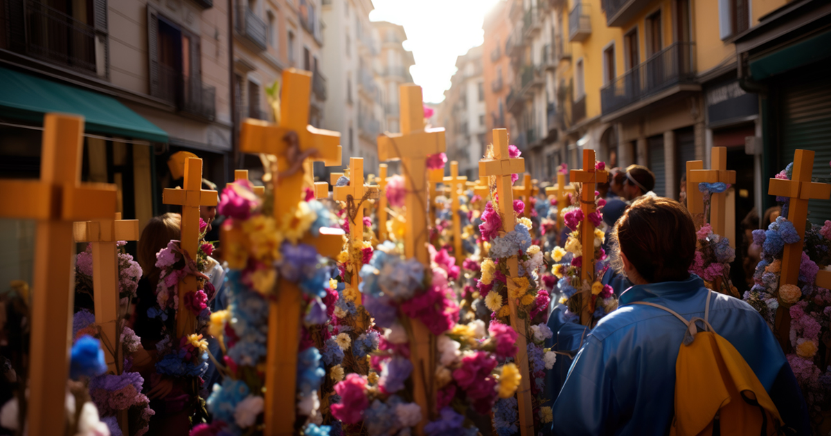 A vibrant street procession featuring many wooden crosses decorated with colorful spring flowers, symbolizing Easter traditions and community renewal.