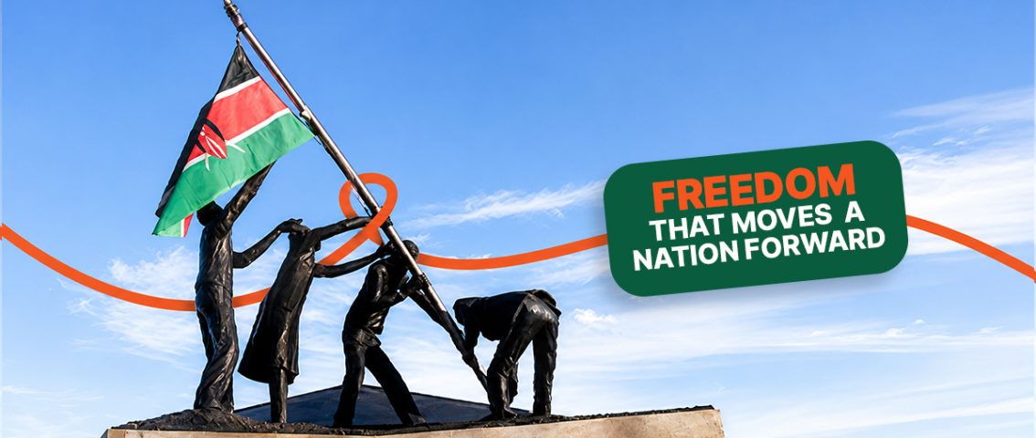 Statue of people raising the Kenyan flag against a clear blue sky, with the text "Freedom That Moves a Nation Forward" celebrating Kenya's Madaraka Day.